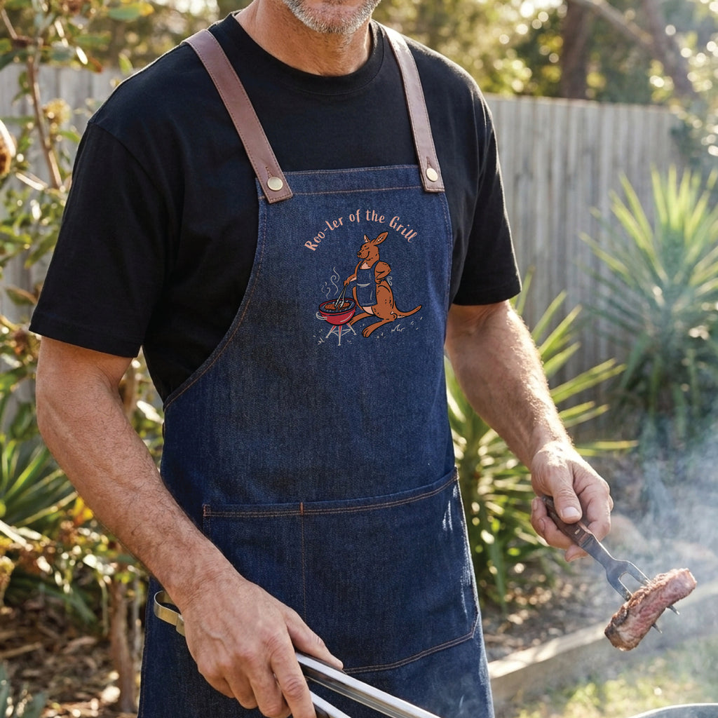 Kangaroo BBQ denim apron featuring a hand-drawn kangaroo cooking at a barbecue with Roo-ler of the Grill slogan