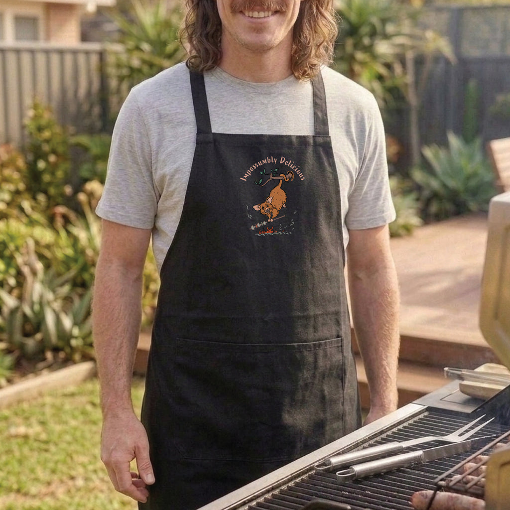 Possum BBQ apron featuring a hand-drawn possum cooking over an open fire with Impossumbly Delicious slogan