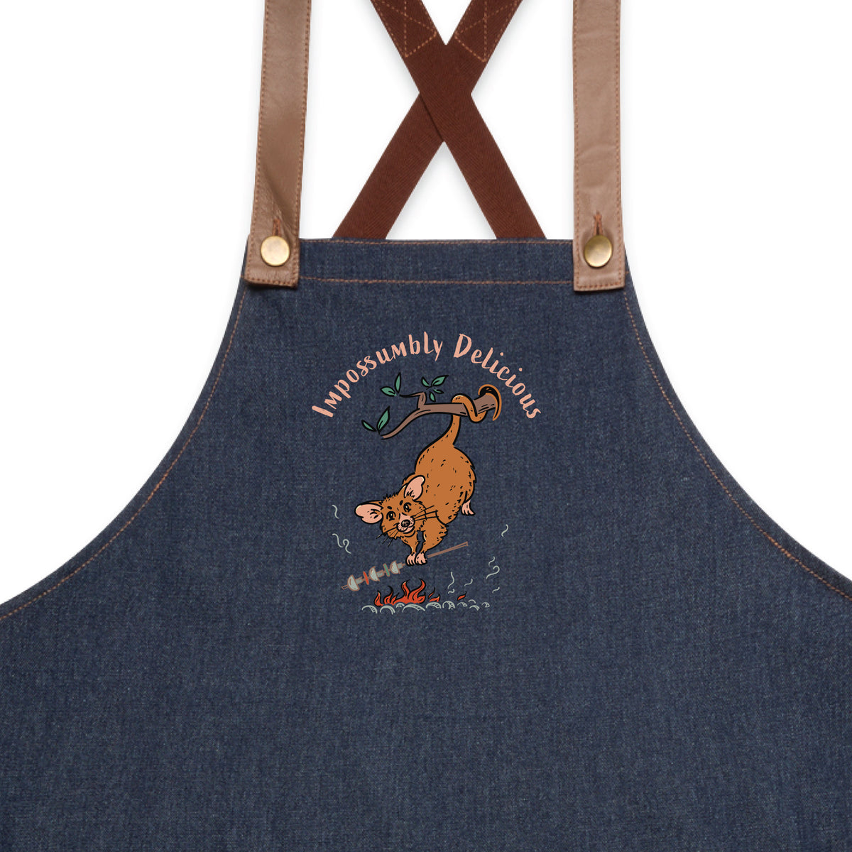 Possum BBQ denim apron featuring a hand-drawn possum cooking over an open fire with Impossumbly Delicious slogan
