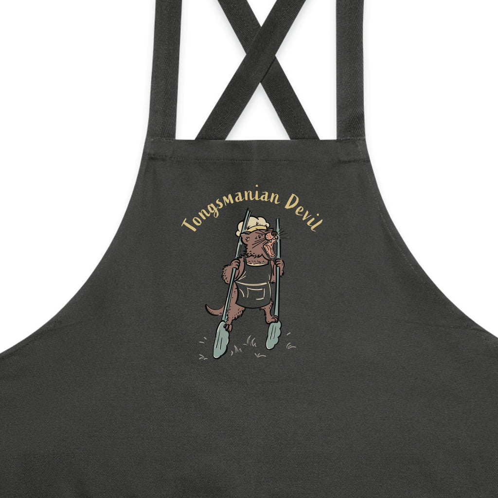 Tasmanian Devil BBQ cotton canvas apron featuring a hand-drawn Tassie devil holding cooking tongs with Tongsmanian Devil slogan