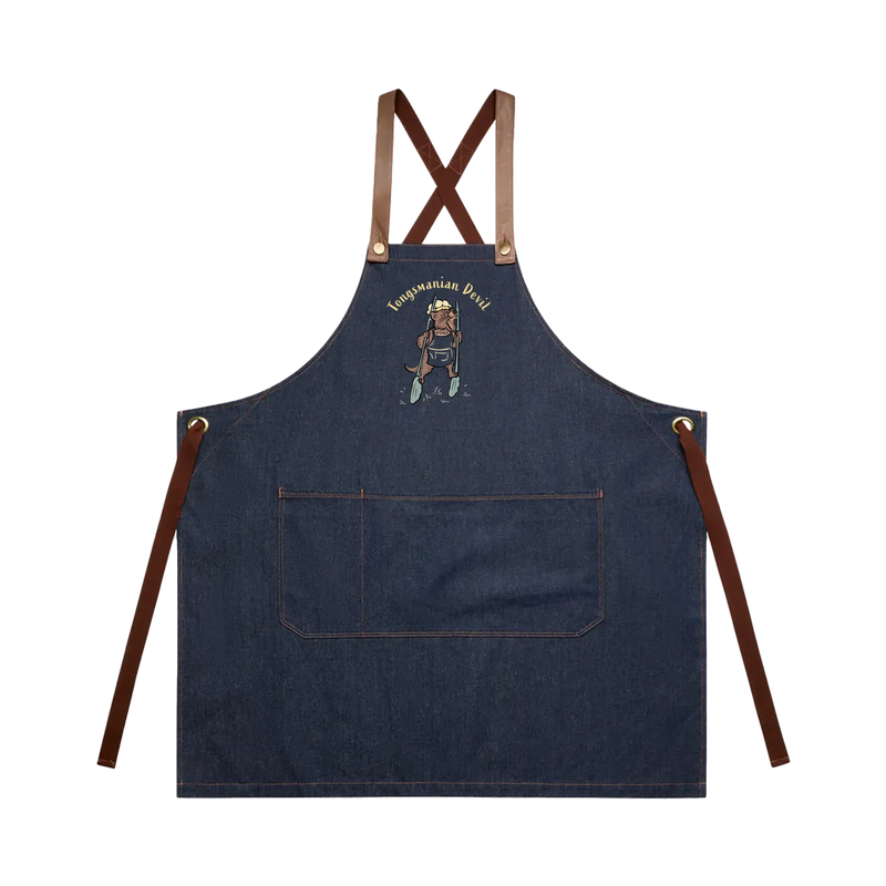 Tasmanian Devil BBQ denim apron featuring a hand-drawn Tassie devil holding cooking tongs with Tongsmanian Devil slogan