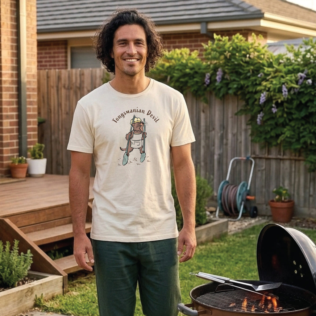 Man wearing a Tongsmanian Devil t-shirt outdoors, featuring a hand-drawn Tasmanian Devil holding cooking tongs, perfect for BBQ enthusiasts and animal lovers