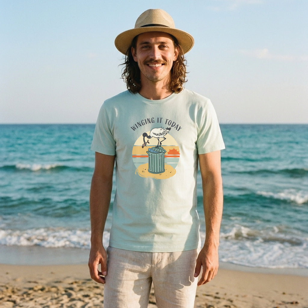 Man wearing a funny ibis t-shirt with hand-drawn Winging It Today design in seafoam